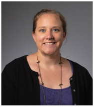A woman with a necklace and black sweater