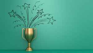 A gold trophy with illustrated stars and celebratory swirls bursting from it against a green background.