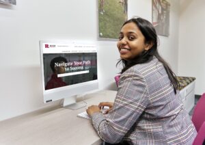 Stuednt using desktop to access a Rutgers website titled "Navigating Your Path To Success". 
