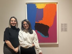 Two women stadning in front of a picture frame at Zimmerli Art Museum. 