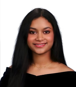 A headshot of a student with brown hair, wearing a black shirt, against a solid white background.